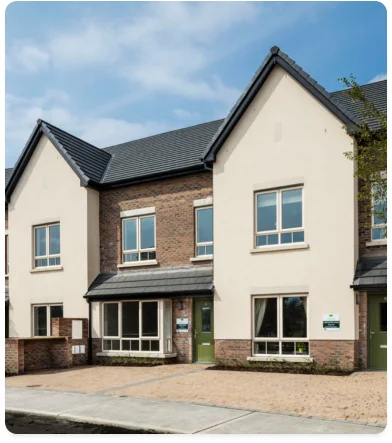 a building with a brick wall and a green door